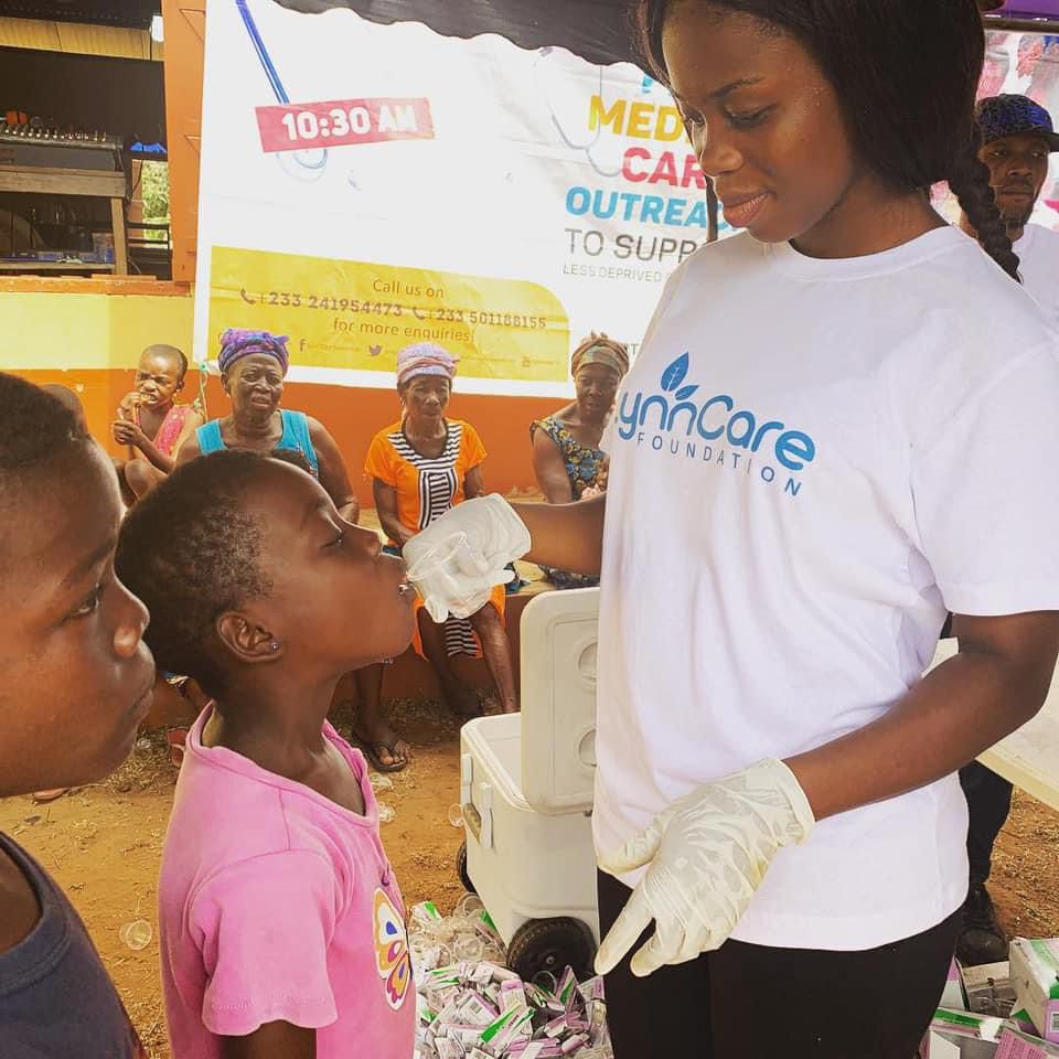 LynnCare Foundation volunteer attending to a child